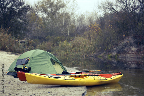 Camping with kayaks on the river bank. © trek6500