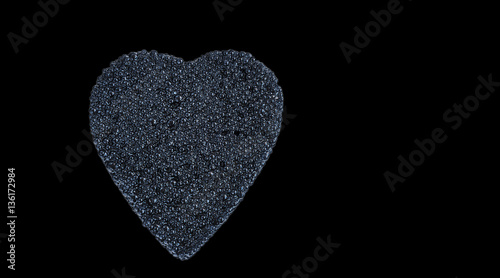 black caviar heart isolated on black with space for text
