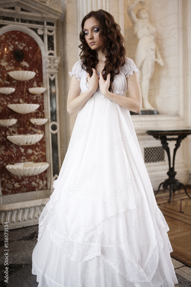 Obraz premium Portrait of a beautiful young victorian lady in white dress
