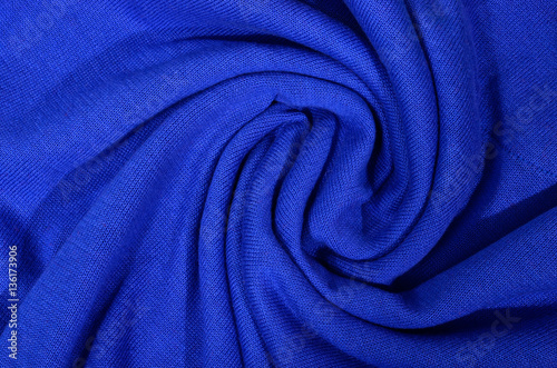 Dark blue folded wool fabric as background.