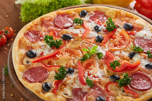 Tasty hot pizza with salami and pepper