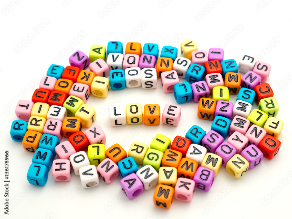 Fototapeta premium Letters spelling 'Love' on a white background.