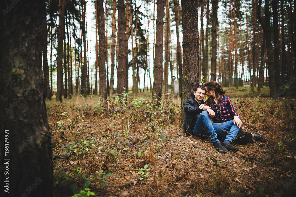 young couple relaxing under a tree young couple relaxing under a tree