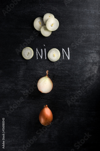 Cut onion over dark chalkboard background