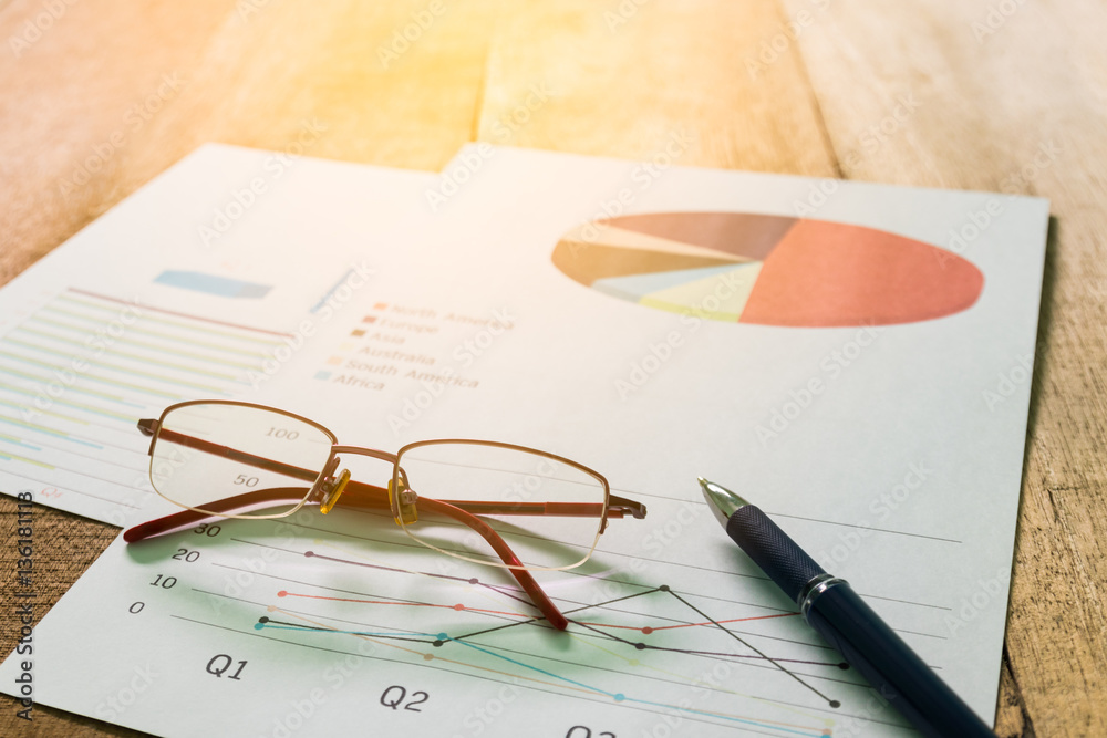 Close up pen with summary report and eyeglasses on table office. Concept of Data Analysis, Investment Planning, Business Analytics. Close up pen with summary report and eyeglasses on table office. Concept of Data Analysis, Investment Planning, Business Analytics.