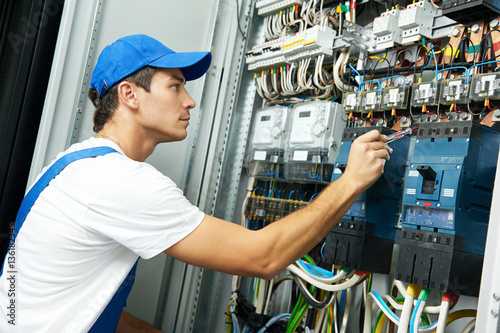 Electrician hand with test voltage screwdriver