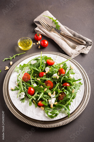 fresh vegetable salad with rucola  tomatos and goat cheese. Healthy food concept.