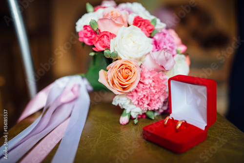 Wedding rings on a background of bridal bouquet