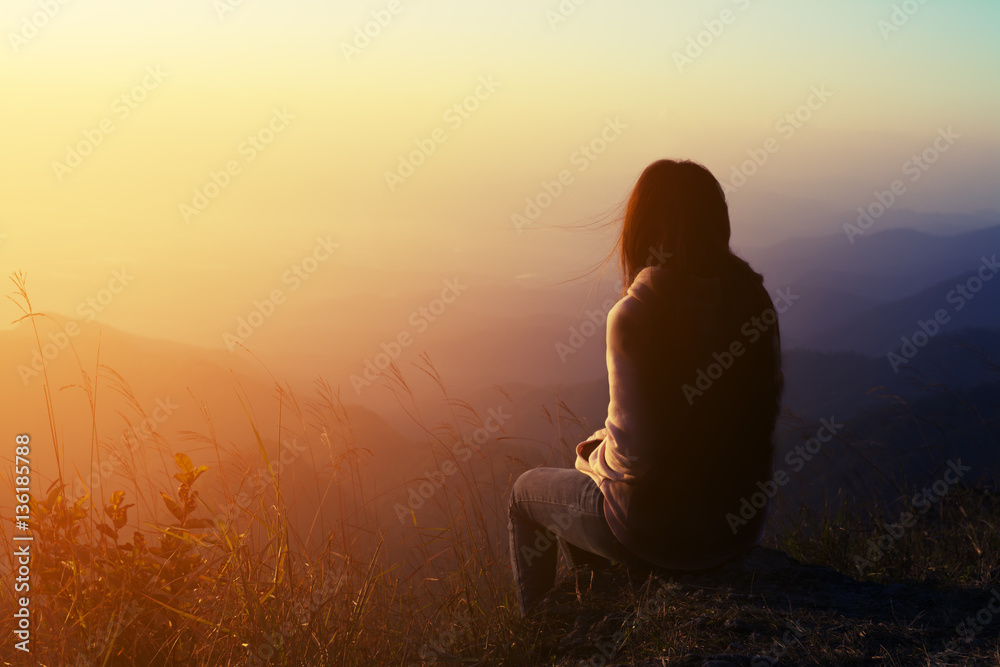 silhouette woman sitting on mountain in morning - obrazy, fototapety, plakaty 