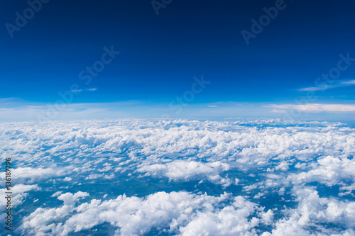 Cloud scape from window of airplane above the sky