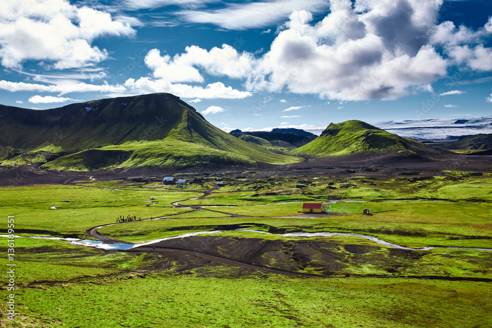 Travel to Iceland. The charming rustic rural house in the national park in Iceland, on beautiful landscape background