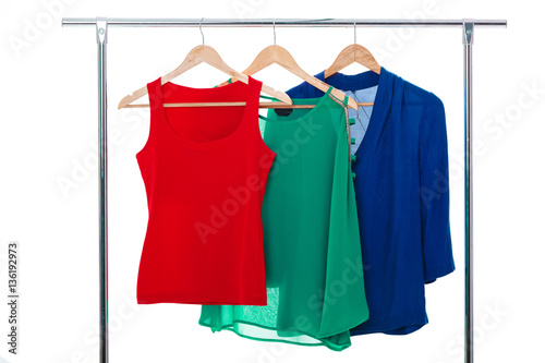 colorful women's shirts on wood hangers on white background. RGB