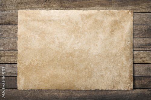 Old paper sheet at wooden background  clipping path