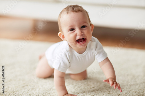 Obraz na płótnie little baby in diaper crawling on floor at home
