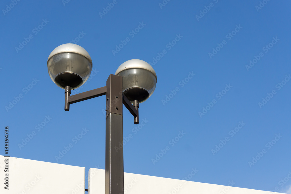 Electric lamp pole with blue sky background. Electric lamp pole with blue sky background.