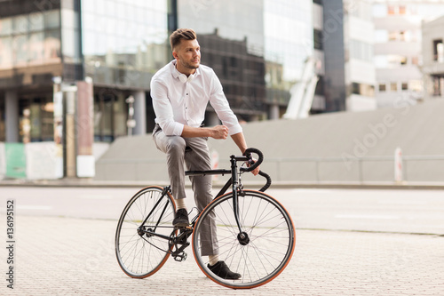 man with bicycle and headphones on city street