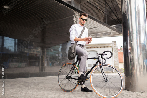 man with bicycle and smartphone on city street