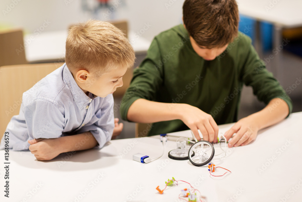 happy children building robots at robotics school
