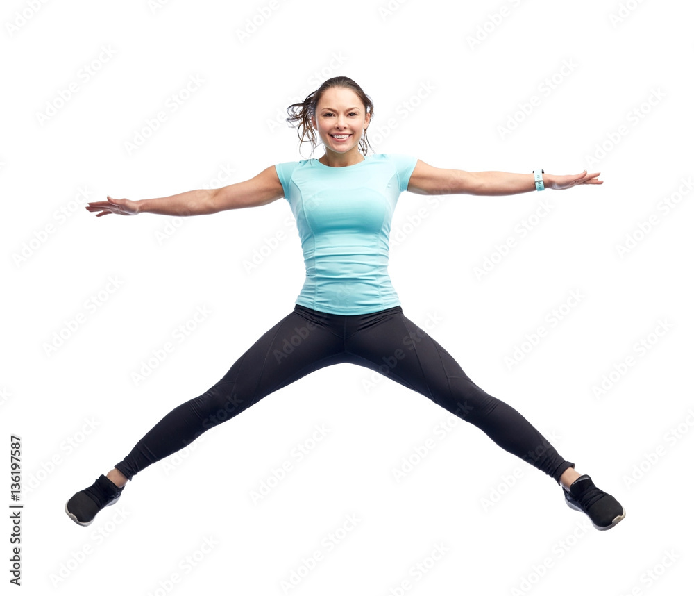 happy smiling sporty young woman jumping in air happy smiling sporty young woman jumping in air