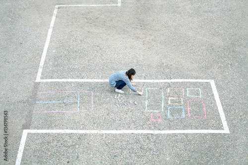 Girl draws chalk house   building