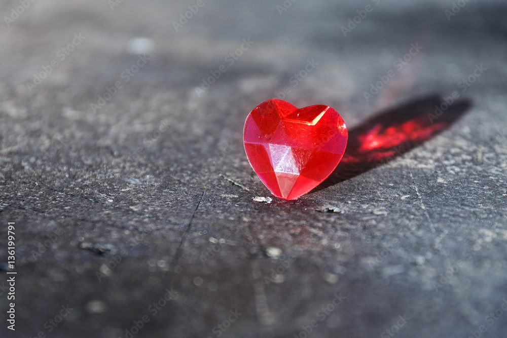 Fototapeta premium Red love heart with reflection on gray stone, valentine's or mother's day