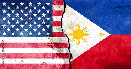 A large crack in the wall. USA flag. Flag of the Philippines