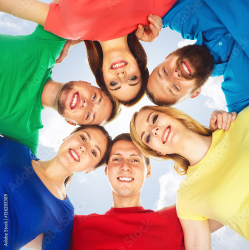Happy students in colorful clothing standing together. Education