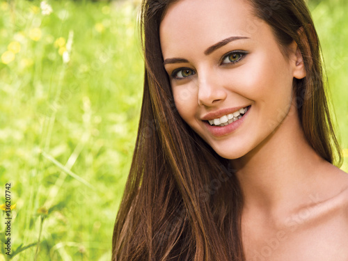 portrait of the young beautiful smiling woman outdoors