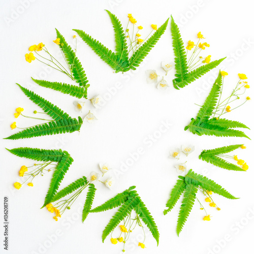 Wreath of jasmine ranunculus and leaves of green fern