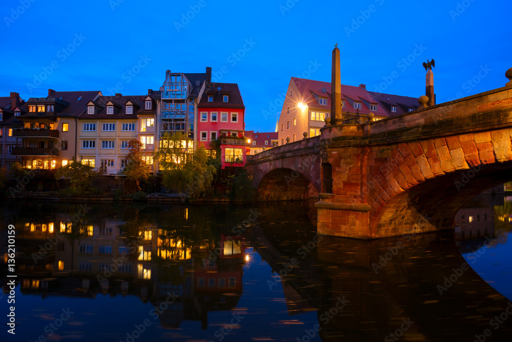 View of Karlsbrucke and Old town of Nuremberg over Pegnitz river at night, Germany