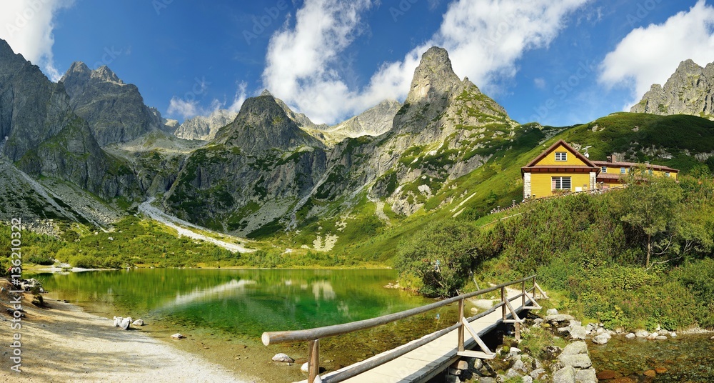 High Tatras in Slovakia. Green lake and monumental peaks. Summer scenic landscape mountain view. Green lake cottage.