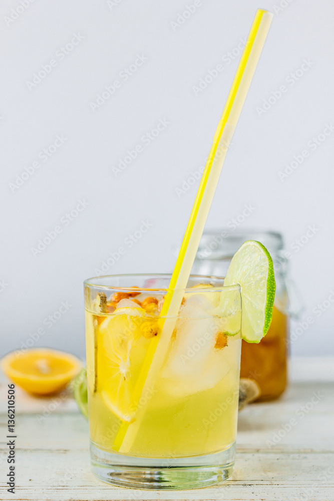 Fototapeta premium Fresh Ginger lemonade over white wooden background