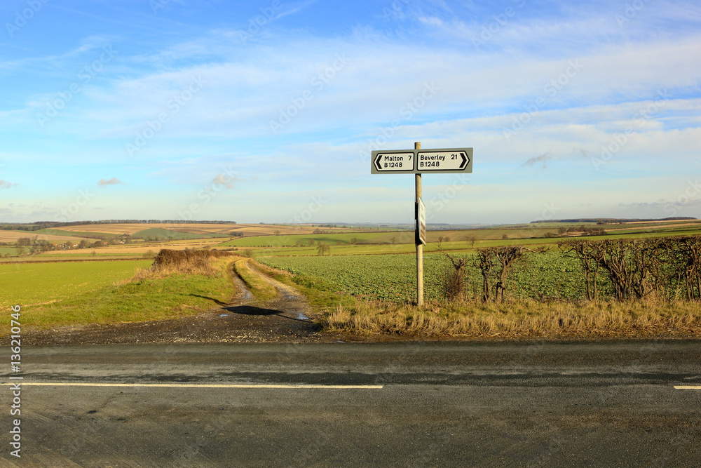 country road sign in a sunny winter landscape