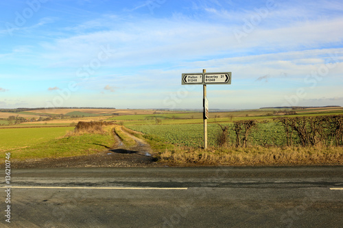 country road sign in a sunny winter landscape
