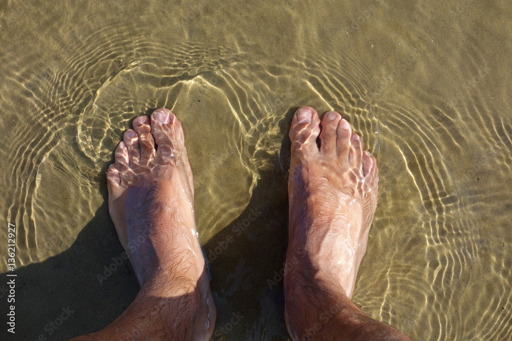 legs, feet on sandy beach legs, feet on sandy beach