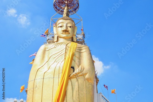 Golden Standing Buddha Statue at Wat Intharawihan in Bangkok, Thailand photo