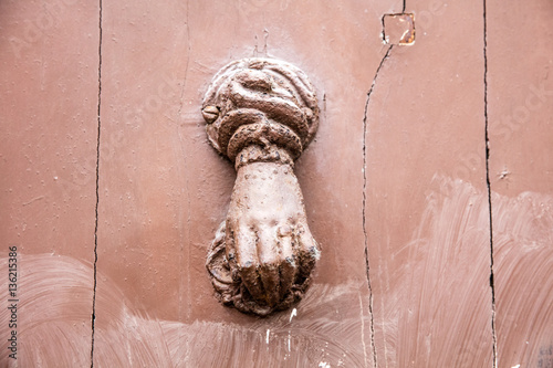 detail, old metal door knocker in shape of woman hand
