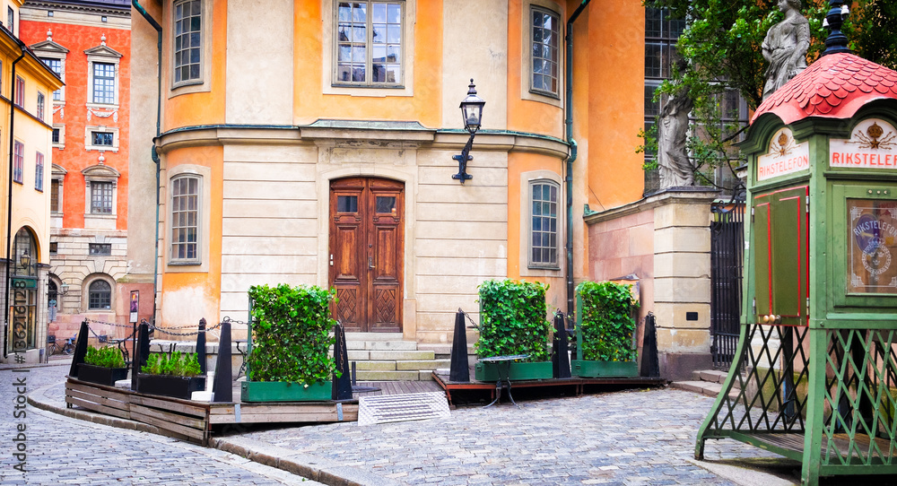 Fototapeta premium Stockholm Sweden beautiful street old buildings and antique public phone booth. Scandinavian style