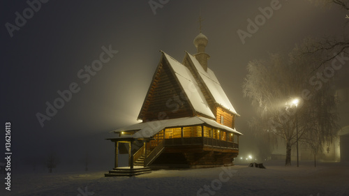 Fairytale night landscape with old wooden church in Suzdal in heavy fog