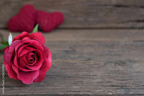 Red rose flower closeup on rustic wooden table