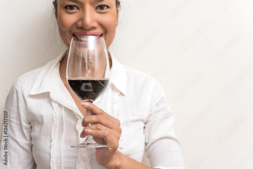 Beautiful business woman holding red wine glass for celebrate Beautiful business woman holding red wine glass for celebrate