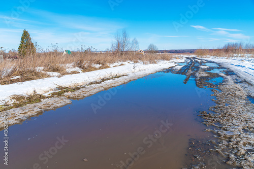 Fototapeta Naklejka Na Ścianę i Meble -  The road during the spring thaw with mud