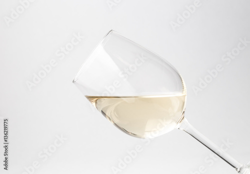 Tilted glass of white wine