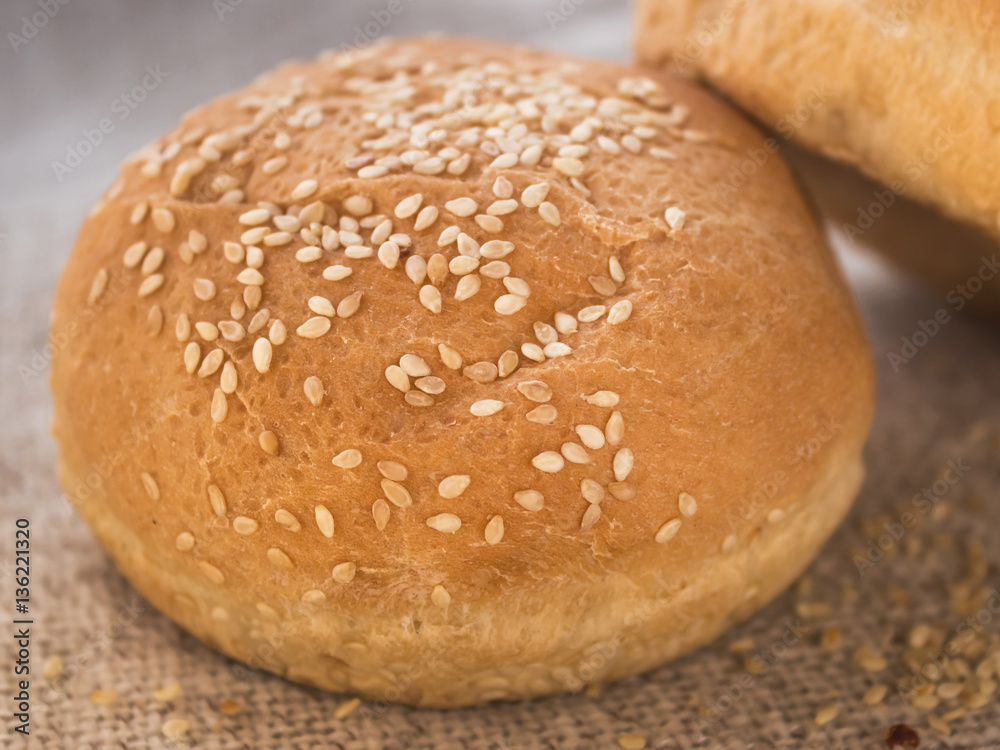 Fresh hamburger buns with sesame seeds. . Fast food.Butter cakes