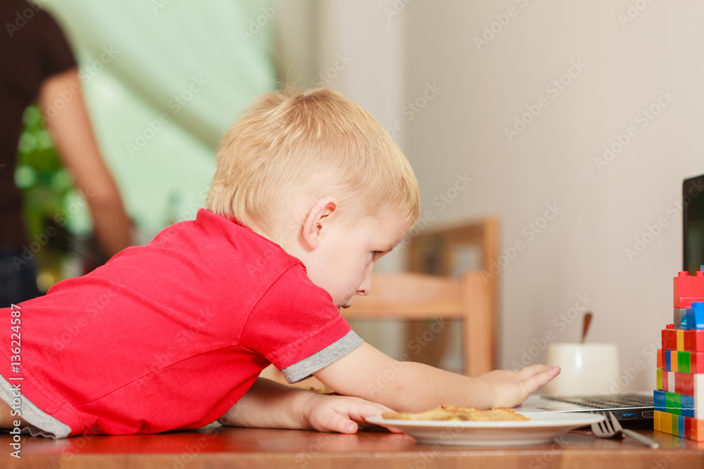 Little boy using laptop computer playing games Little boy using laptop computer playing games