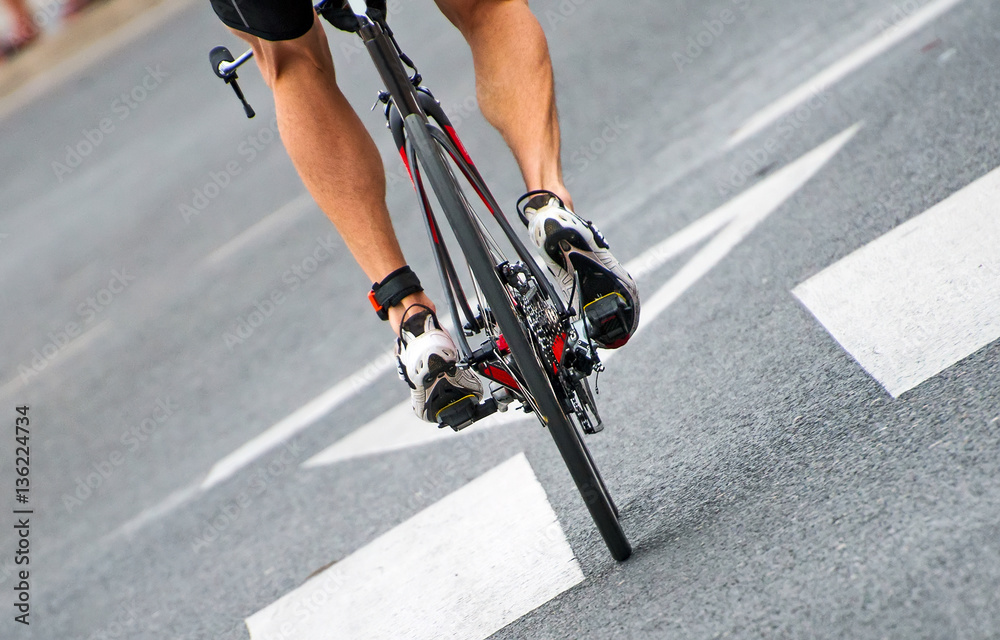 Naklejka premium Unrecognizable professional cyclist during the bicycle competition. Back view.