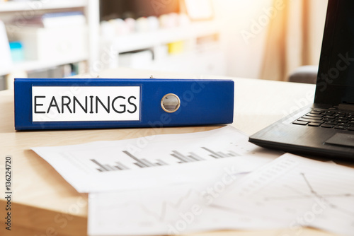 Office folder with inscription Earnings - on Office Desktop with