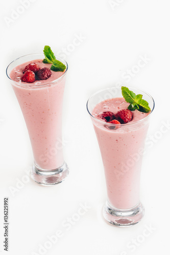 Raspberry smoothie with mango isolated on white background
