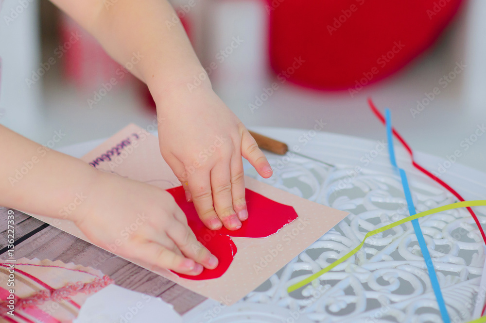 girl glues heart. She makes paper postcard girl glues heart. She makes paper postcard