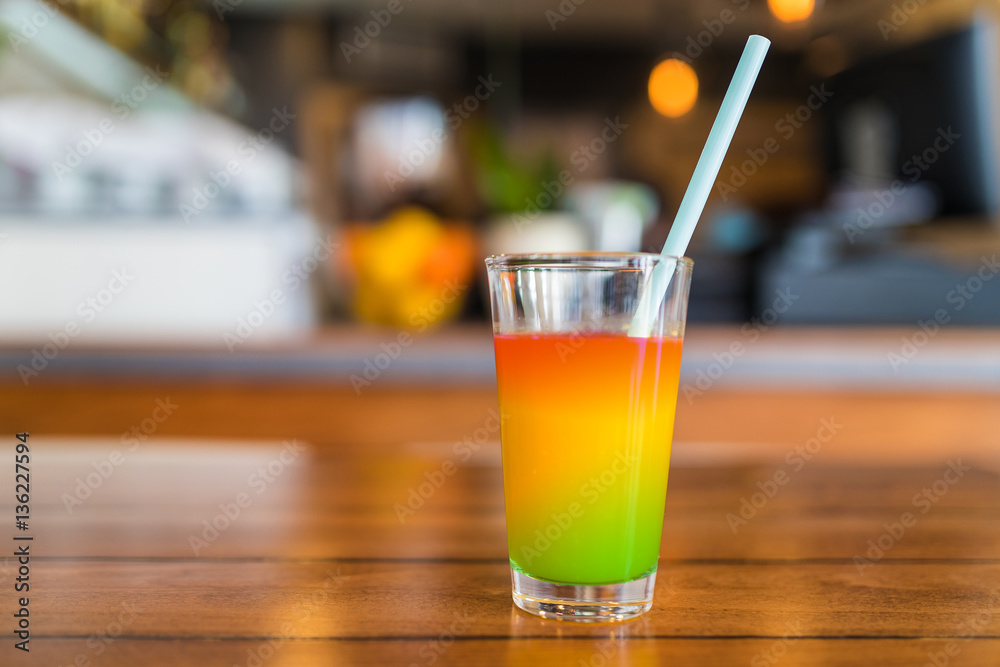 Fresh green and orange juice in a glass. Fresh green and orange juice in a glass.